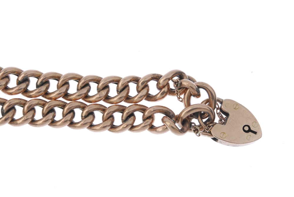 An early 20th century 9ct gold bracelet. The curb-link chain, to the heart-shape padlock clasp. - Image 3 of 3