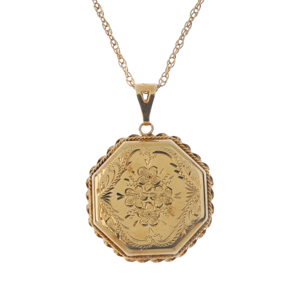 A 9ct gold locket. Of hexagonal outline, with engraved floral and foliate motif, to the rope-twist