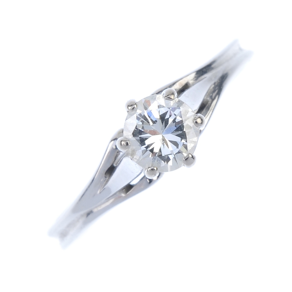 A diamond single-stone ring. The brilliant-cut diamond within a raised claw setting, to the