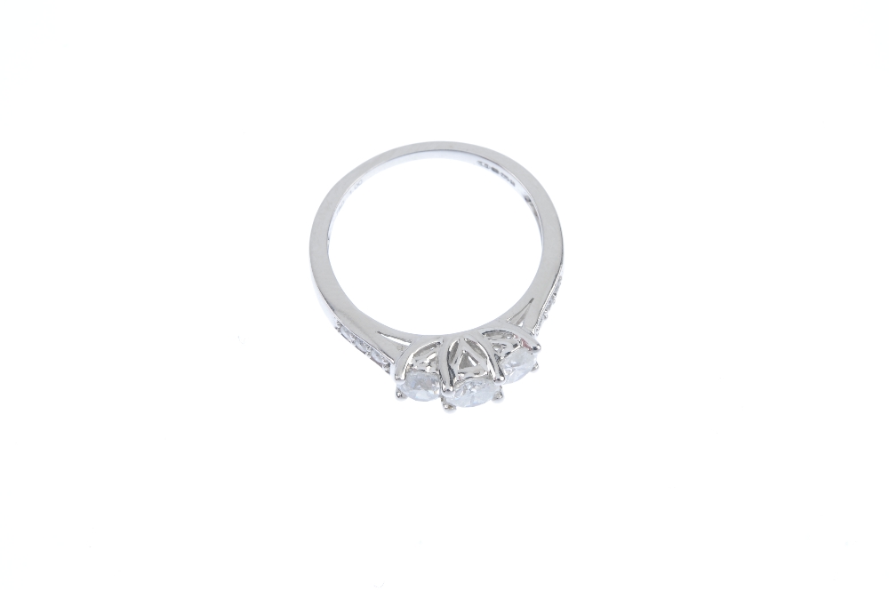 An 18ct gold diamond three-stone ring. The brilliant-cut diamond stepped line, with similarly-cut - Image 2 of 3