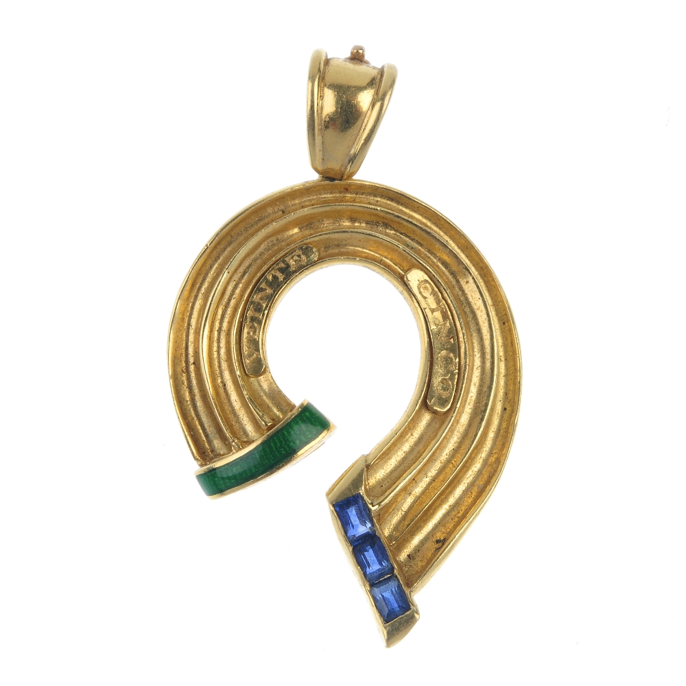 An 18ct gold sapphire pendant. Designed as a stylised ribbon, the curved panel, with green enamel