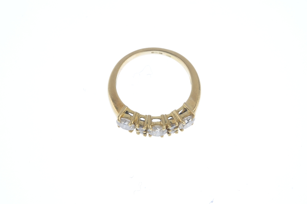 An 18ct gold diamond three-stone ring. The brilliant-cut diamond line, with square-shape diamond - Image 2 of 3