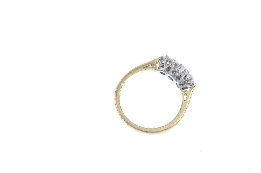 An 18ct gold diamond three-stone ring. The graduated brilliant-cut diamond line, to the plain - Image 3 of 3