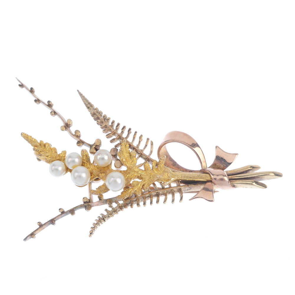 A 9ct gold cultured pearl foliate brooch. Designed as a fern, with cultured pearl accents and bow