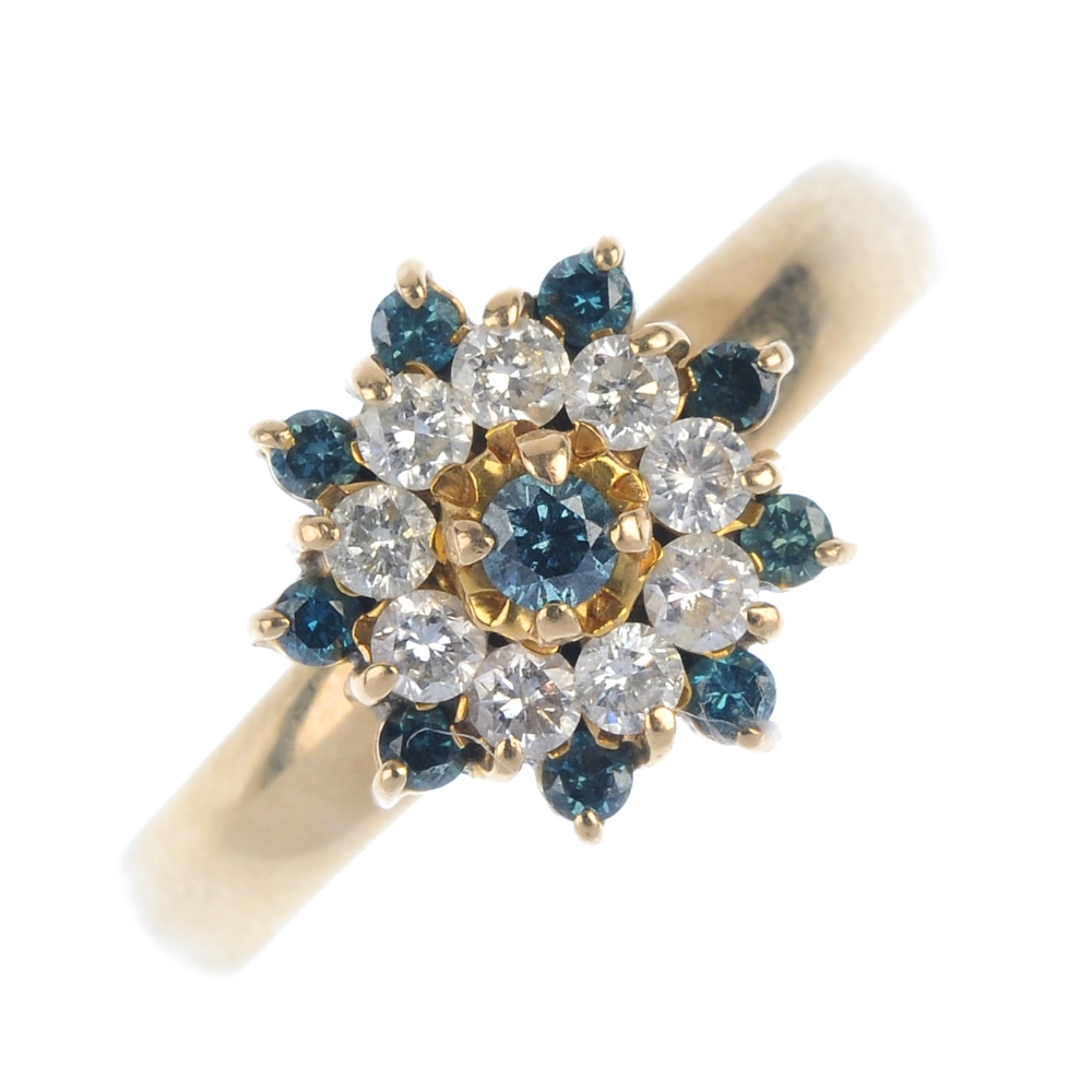 A diamond and colour treated diamond cluster ring. The brilliant-cut colour treated 'blue'