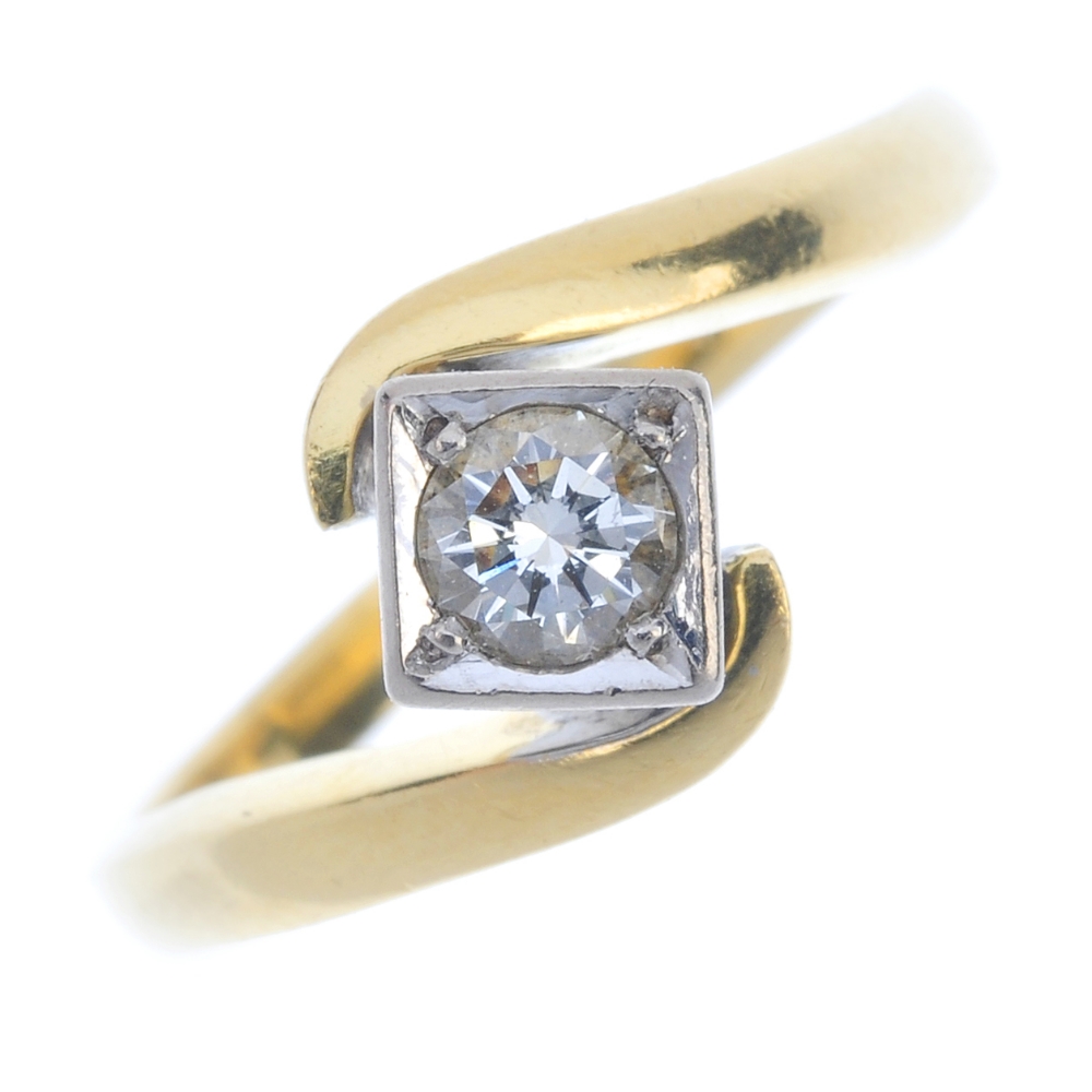 An 18ct gold diamond single-stone crossover ring. The brilliant-cut diamond, within a square-shape