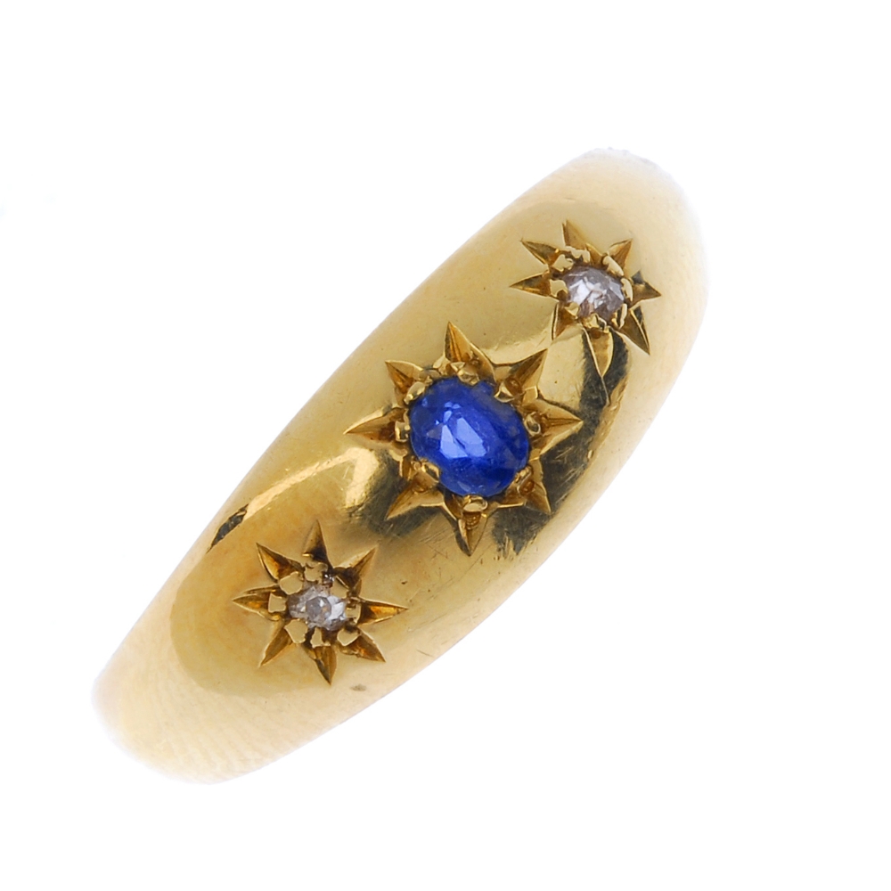 An Edwardian 18ct gold sapphire and diamond ring. The oval-shape sapphire and single-cut diamond