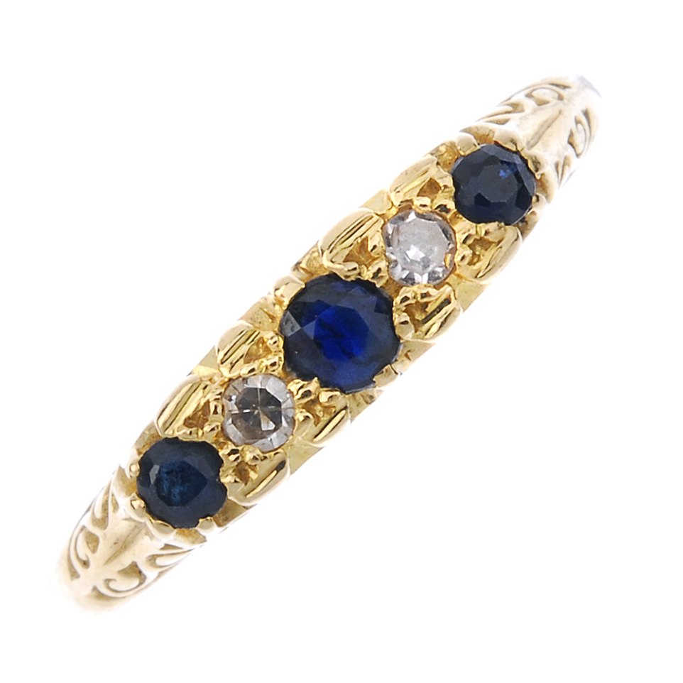 A sapphire and diamond five-stone ring. The alternating graduated circular-shape sapphire and