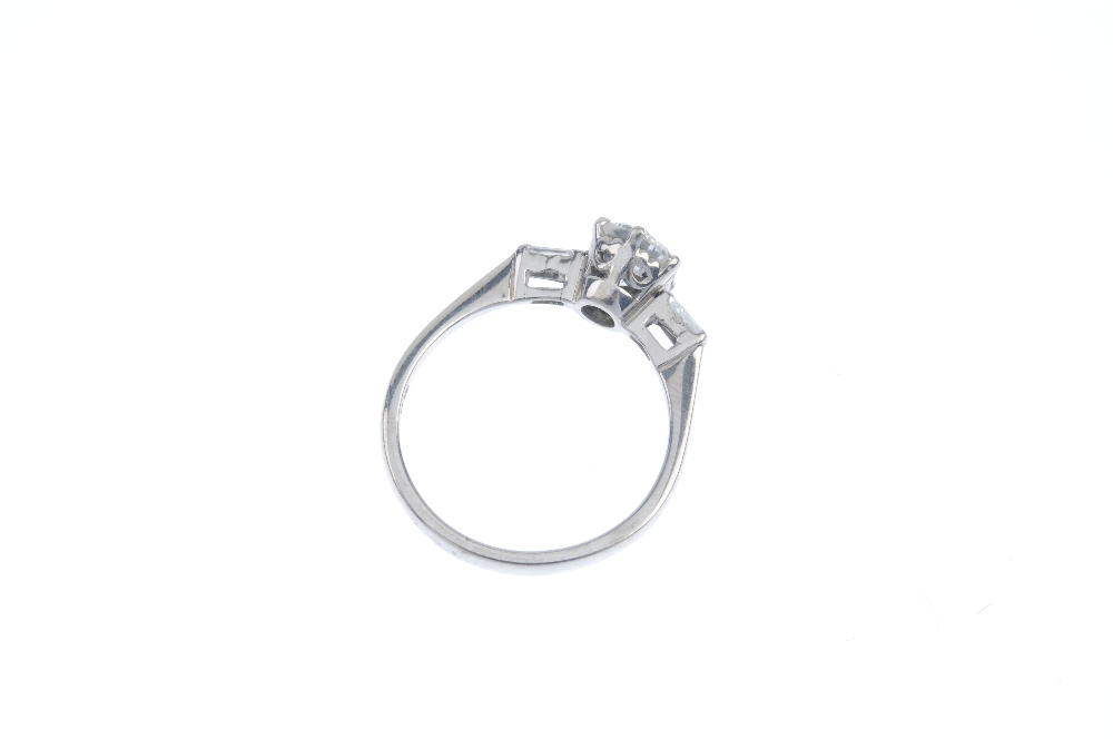An 18ct gold diamond single-stone ring. The brilliant-cut diamond, to the tapered baguette-cut - Image 3 of 3