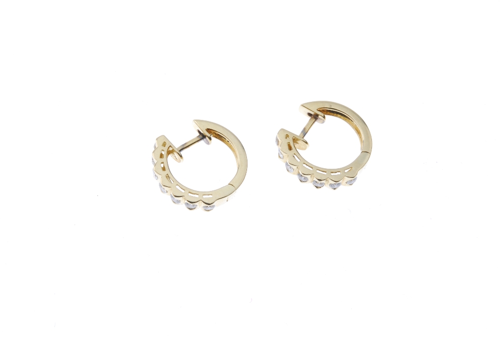 A pair of diamond ear hoops. Each designed as a brilliant-cut diamond line, to the plain half-hoop - Image 2 of 2
