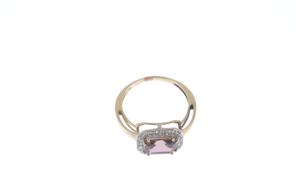 A topaz dress ring. The pink topaz, within a brilliant-cut diamond surround, to the tapered band. - Image 2 of 3