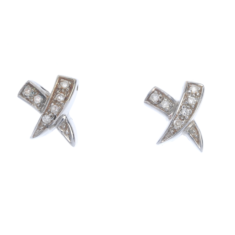 A selection of diamond jewellery. To include a pair of cross ear studs, a 9ct gold cross pendant,
