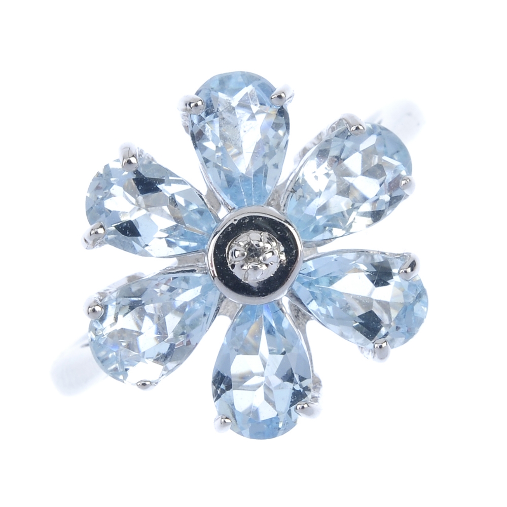 A 9ct gold aquamarine floral cluster ring. The single-cut diamond collet, within a pear-shape