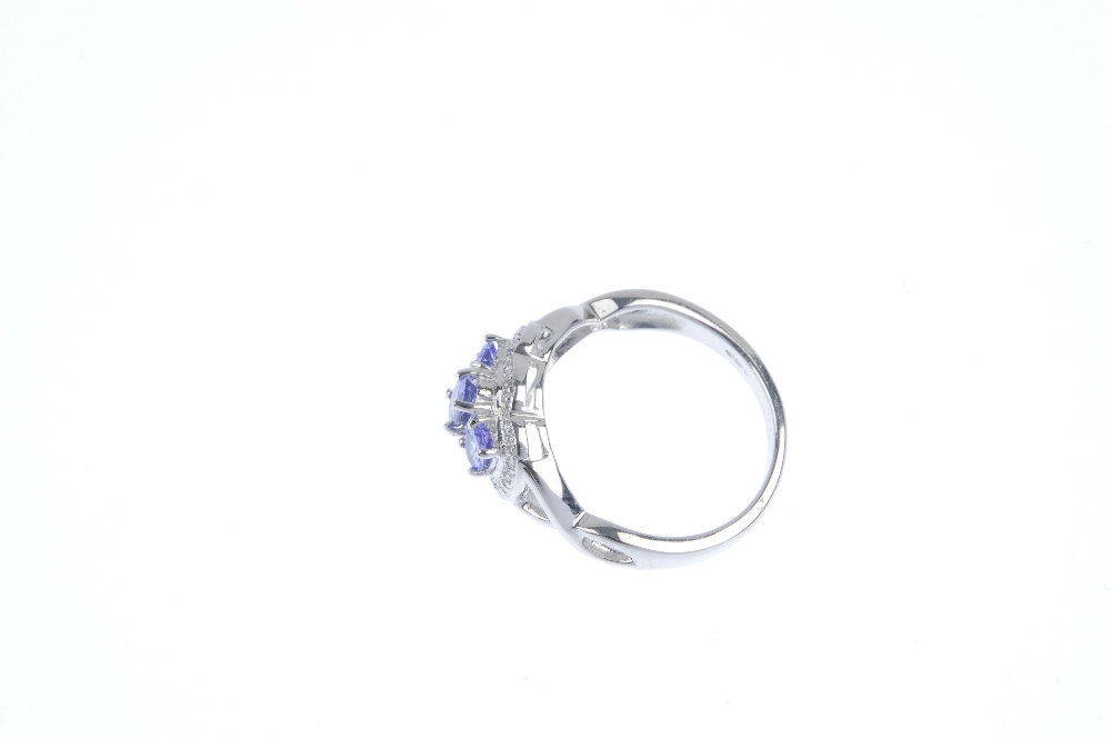 A 9ct gold tanzanite and diamond dress ring. The graduated oval-shape tanzanite line, within a - Image 3 of 4