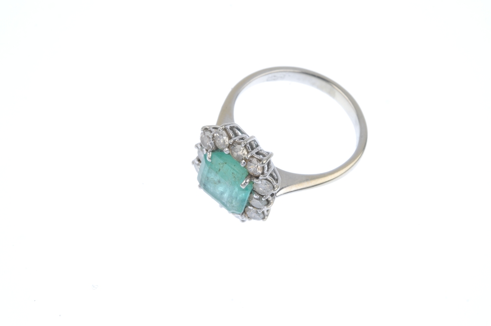 An emerald and diamond cluster ring. The square-shape emerald, within a brilliant-cut diamond - Image 2 of 4