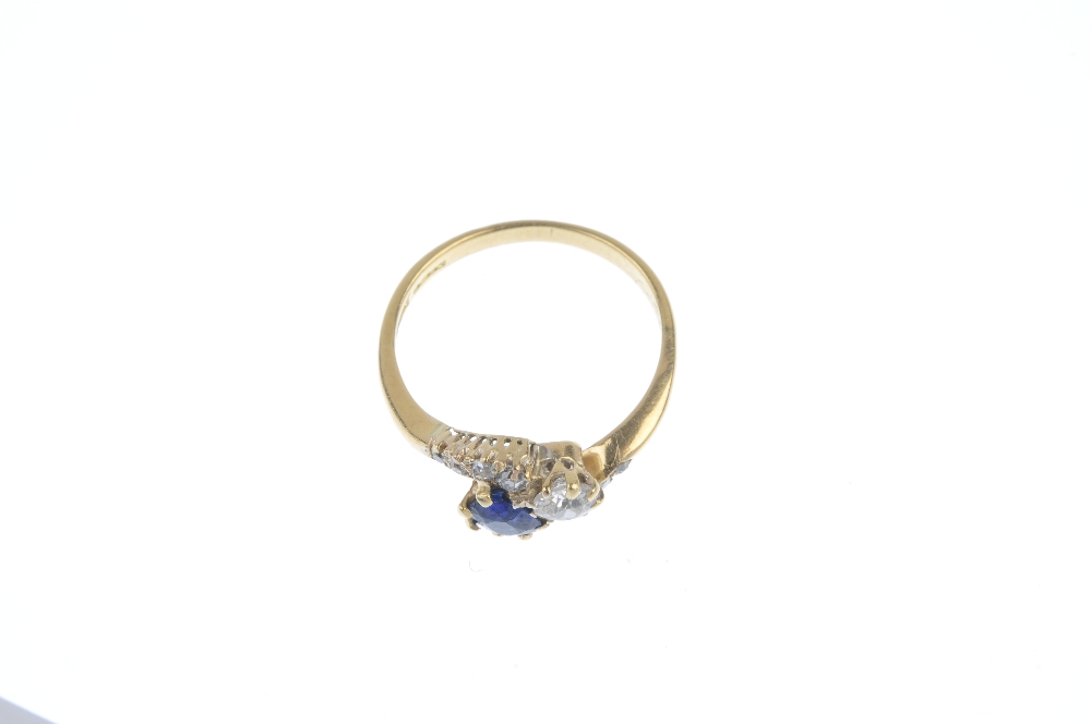 An early 20th century 18ct gold sapphire and diamond two-stone crossover ring. The cushion-shape - Image 2 of 3