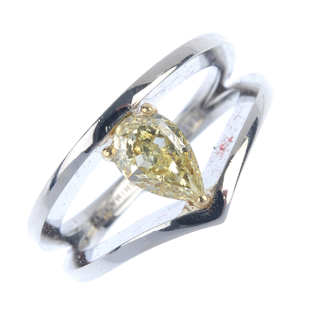 A coloured diamond dress ring. The pear-shape fancy light yellow diamond, weighing 0.76ct, within
