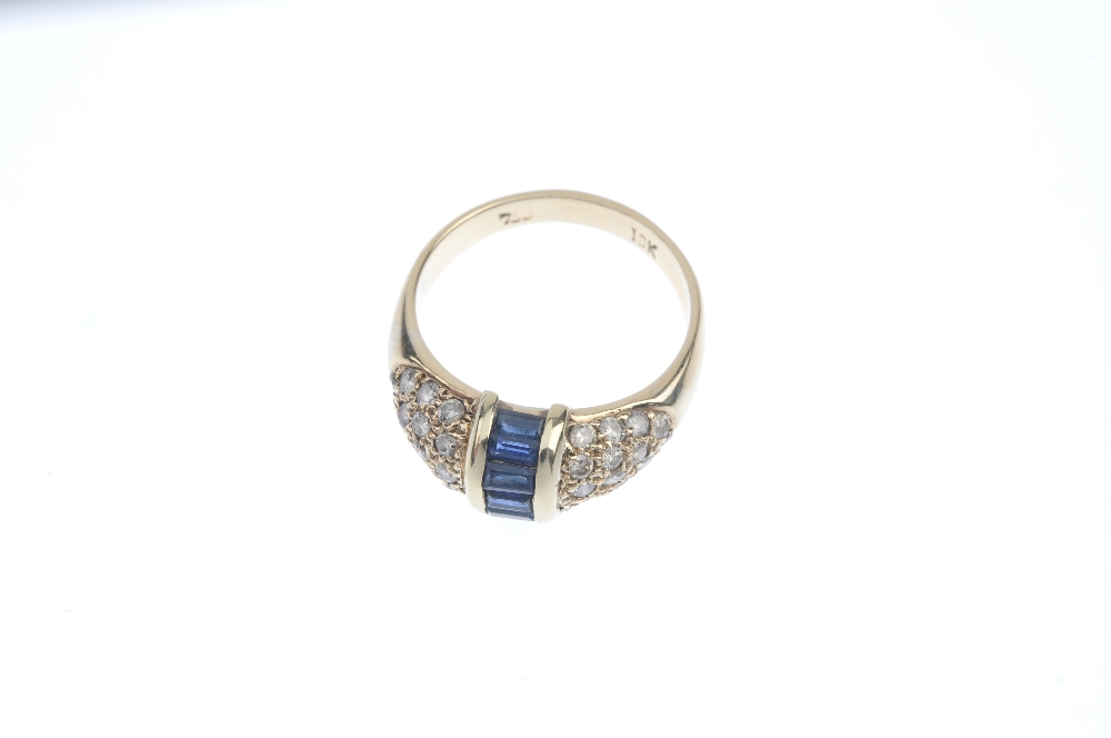 A sapphire and diamond dress ring. The rectangular-shape sapphire line, with bar sides, to the - Image 2 of 4