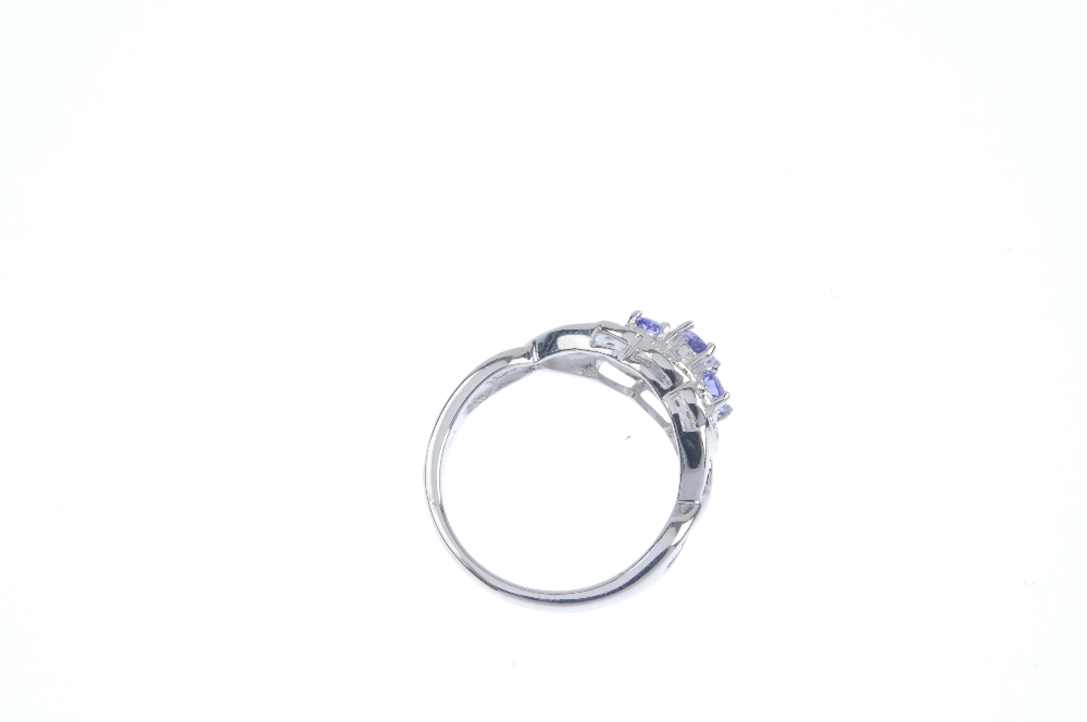 A 9ct gold tanzanite and diamond dress ring. The graduated oval-shape tanzanite line, within a - Image 4 of 4