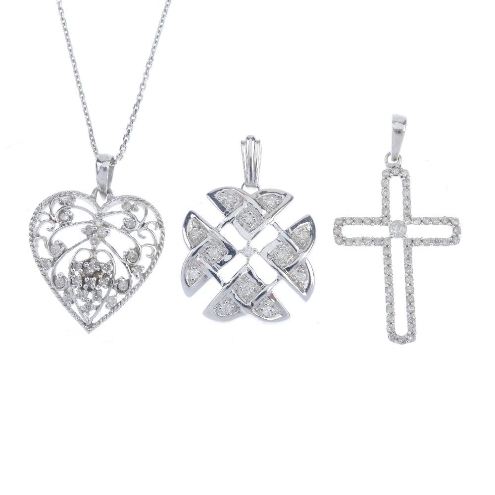 A selection of three 9ct gold diamond pendants. To include a diamond cross pendant, a diamond