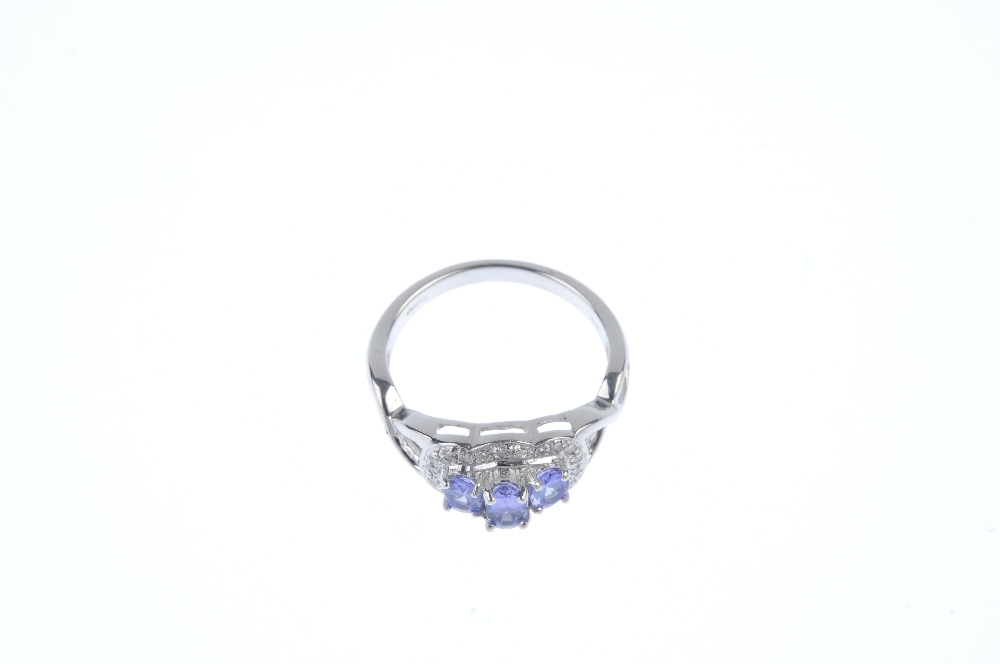 A 9ct gold tanzanite and diamond dress ring. The graduated oval-shape tanzanite line, within a - Image 2 of 4