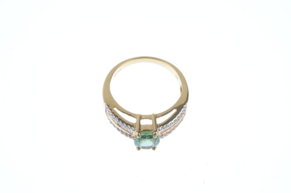 An 18ct gold tourmaline and diamond dress ring. The oval-shape green tourmaline, to the square-shape - Image 2 of 3