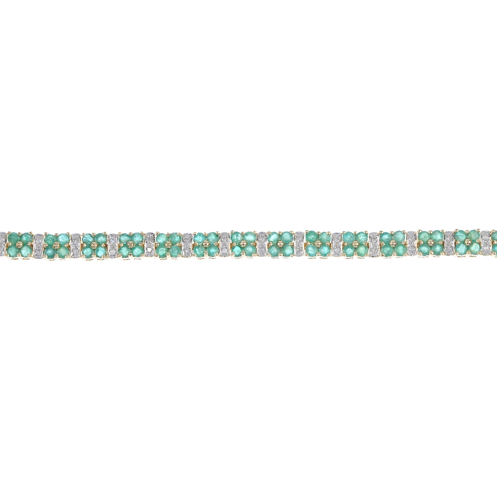 A 14ct gold emerald and diamond bracelet. Designed as a series of circular-shape emerald