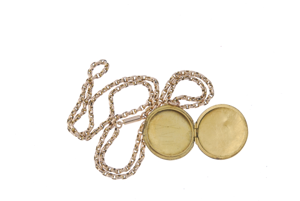 An early 20th century locket. Of circular outline, with engraved foliate motif, suspended from a - Image 2 of 2