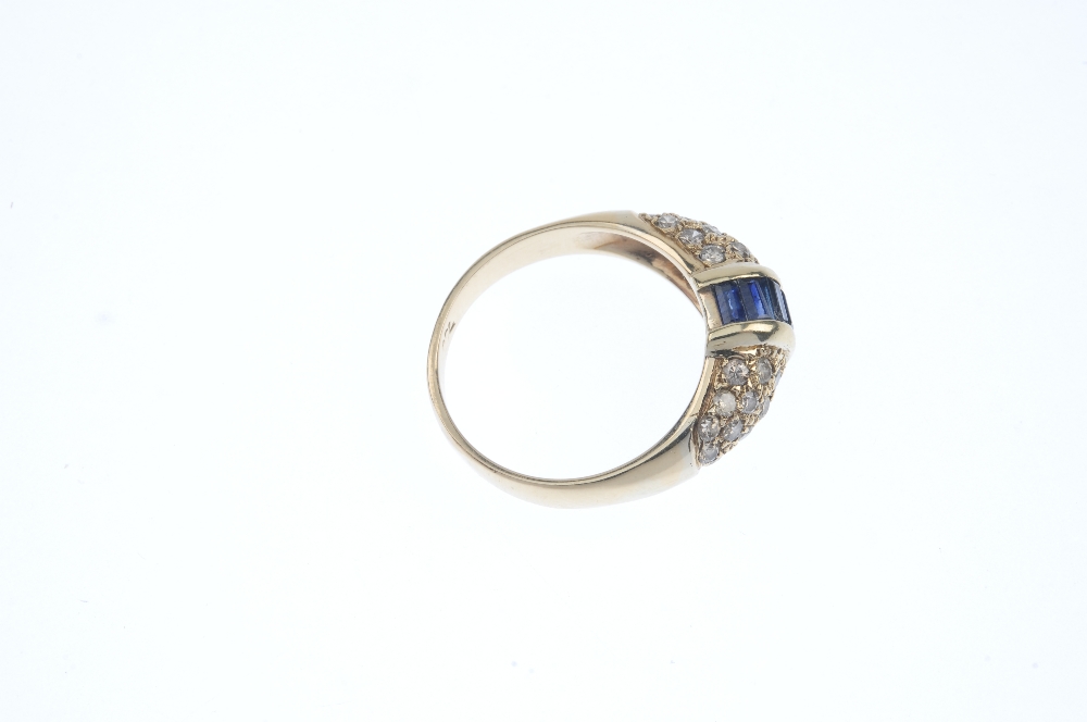 A sapphire and diamond dress ring. The rectangular-shape sapphire line, with bar sides, to the - Image 4 of 4