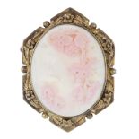 A late 19th century conch shell cameo brooch. The oval shell carved to depict Bacchus, to the