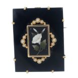 A late 19th century onyx pietra dura gold and split pearl brooch. Designed as a rectangular block of