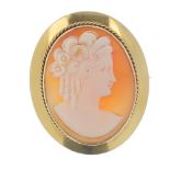 A cameo brooch. The shell carved to depict a lady in profile with ringlets in her hair, to the