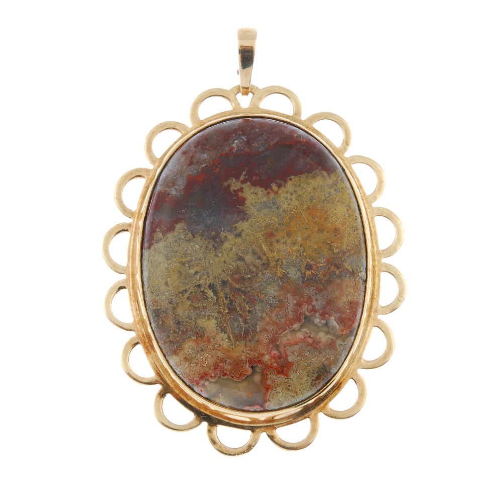 A 9ct gold agate pendant. The oval agate cabochon, within a scalloped border. Hallmarks for
