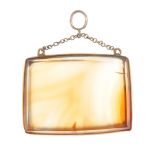 An early 20th century 9ct gold mounted agate pendant. The rectangular bevel edged agate, mounted