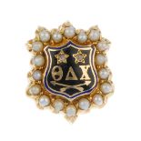 An early 20th century gold diamond, split pearl and enamel fraternity pin. The 'Theta Delta Chi'