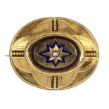 A late Victorian 18ct gold mourning brooch. Of oval outline, the blue enamel starburst with split