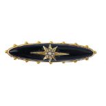 A late 19th century gold memorial brooch. Designed as a marquise-shape onyx set to the central