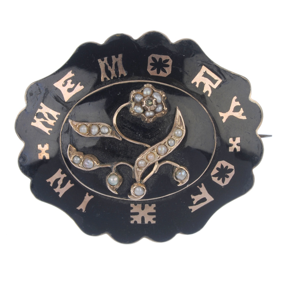 A mid Victorian enamel memorial brooch, circa 1870. The split pearl forget-me-not, atop a black