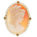 A shell cameo brooch. The oval-shape brooch with carved shell depicting a lady with ringlets, to the