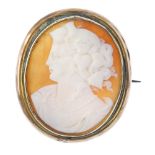 A cameo brooch. The oval-shape shell, carved to depict a lady in profile, to the rope-twist