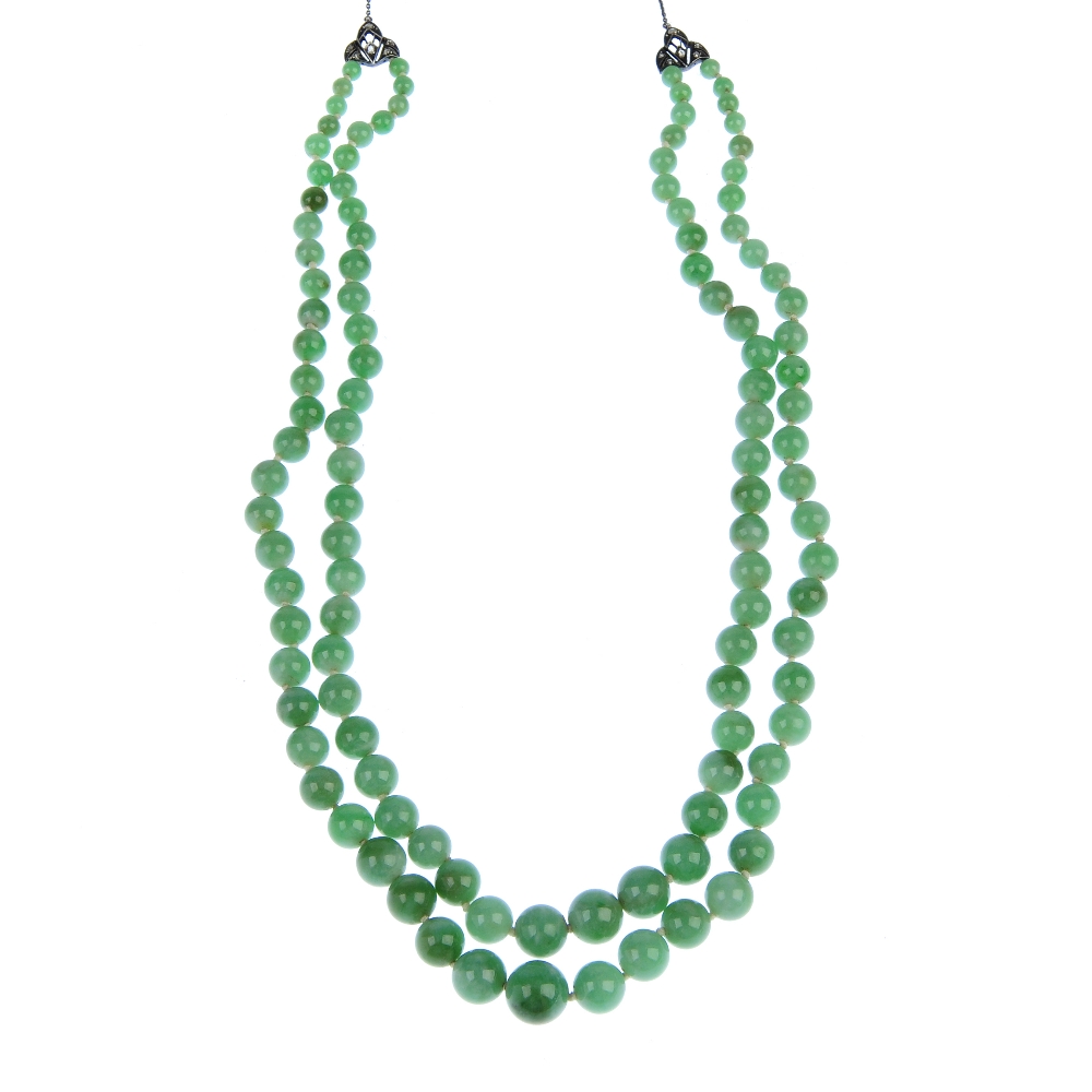 A jade bead necklace. Comprising two rows of graduated spherical beads measuring 1 to 0.4cms to