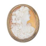 A late 19th century 18ct gold shell cameo brooch. Of oval outline, carved to depict a bacchante,