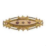 An early 20th century 9ct gold brooch. The marquise shape brooch set with two rubies and a diamond