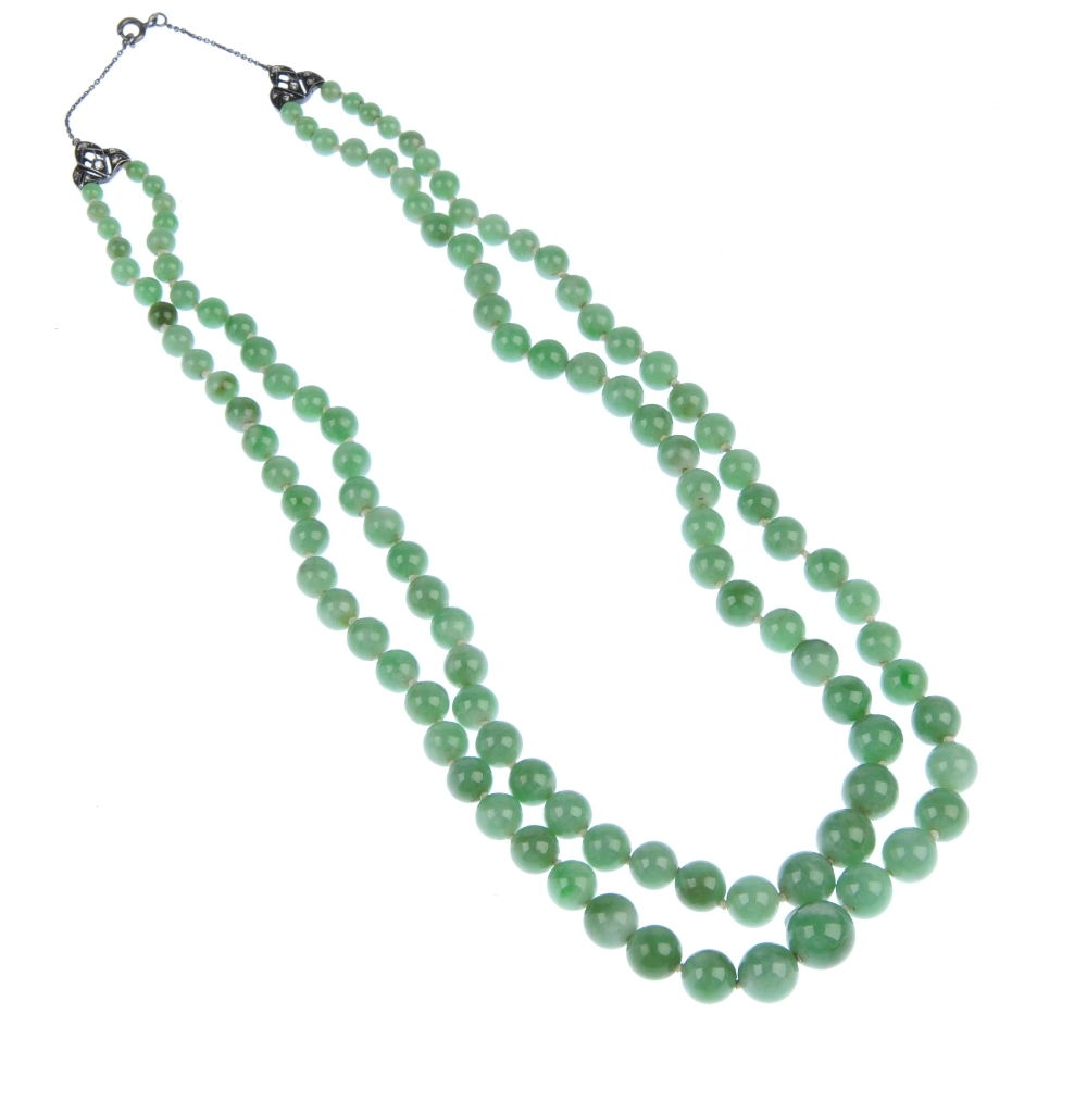 A jade bead necklace. Comprising two rows of graduated spherical beads measuring 1 to 0.4cms to - Image 2 of 2