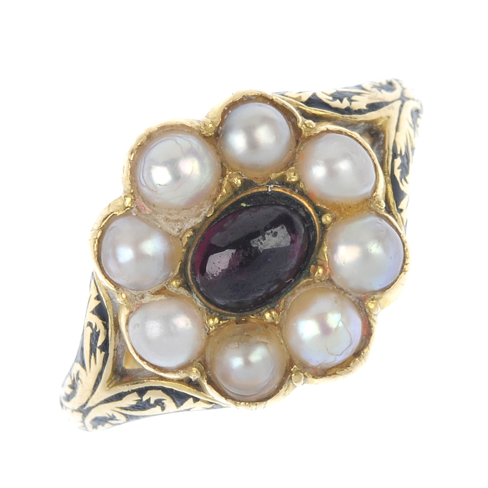 An early 19th century 18ct gold memorial ring. Designed as a central oval-shape cabochon garnet,