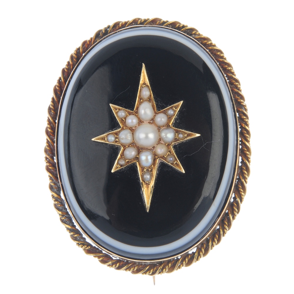 A late 19th century gold split pearl and onyx mourning brooch. The oval-shape onyx cabochon with a
