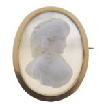 A cameo brooch. The oval chalcedony panel carved to depict a lady within a plain mount. Length 3.