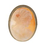 A 9ct gold cameo brooch. Of oval outline carved to depict the side profile of a lady to the rope-