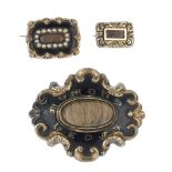 Three mid to late Victorian memorial brooches. The largest with a central oval-shape glazed hair