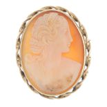 A 9ct gold cameo brooch/pendant. The oval shape carved shell depicting a classical lady, with